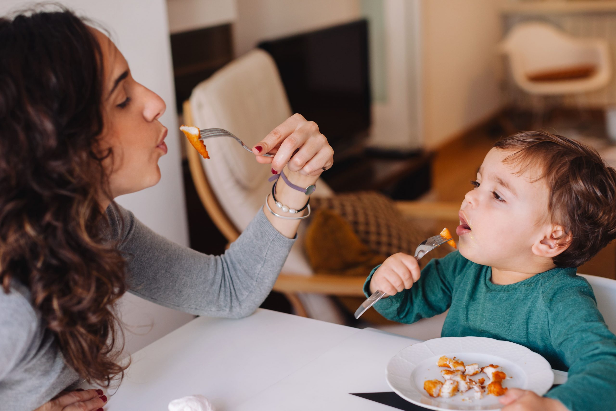 mother and child enjoying some chicken